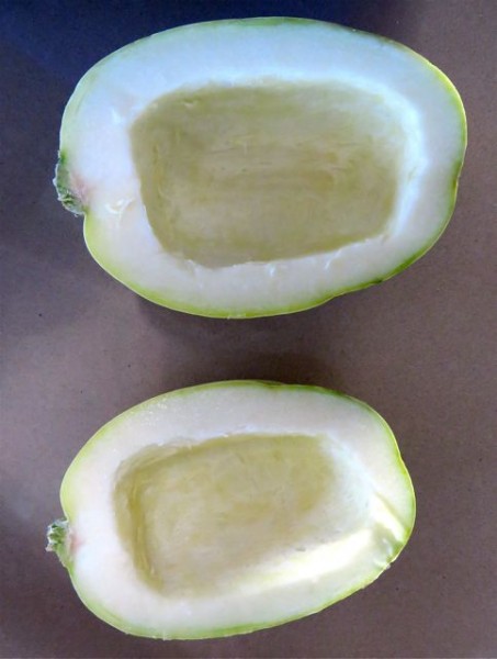 First step after washing the squash, cut it in half, lengthwise.  Then scoop out the seeds.