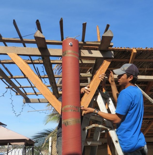 You see two sets of hands.  Lupe and Jose were stabilizing the cement post.